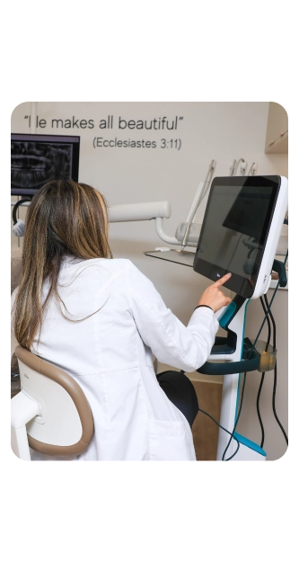 Dr. Stephanie working at the chairside screen in a Restore Dental treatment room