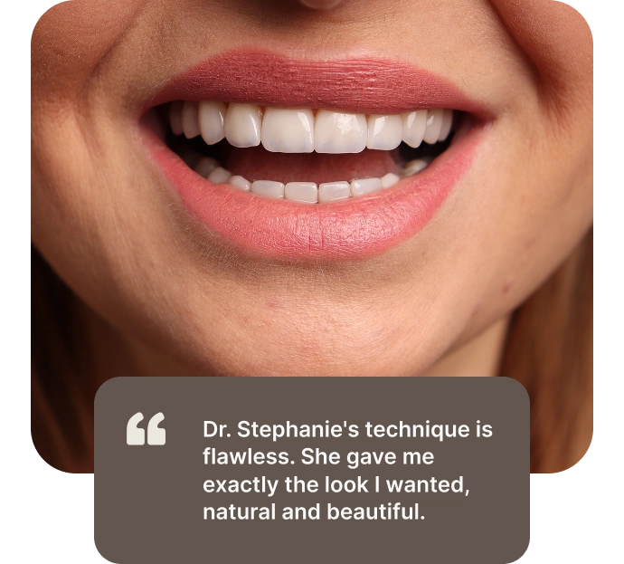 Patient smile after treatment, with the review: Dr. Stephanie's technique is flawless. She gave me exactly the look I wanted, natural and beautiful.