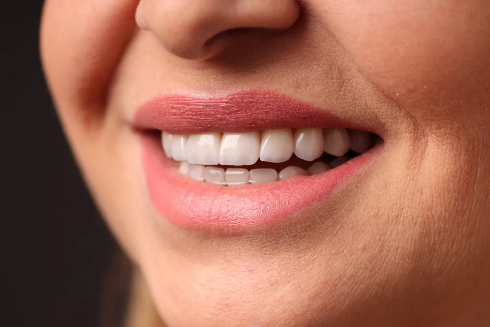 Close up of a finished smile against a dark background