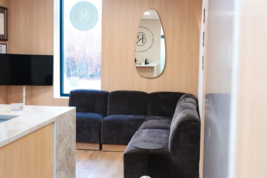 Lounge seating and side table in the waiting area of the Peabody dental office