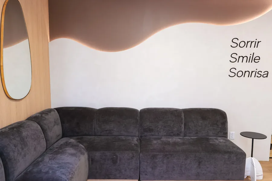 Velvet sofa and oval mirror in the Restore Dental waiting room